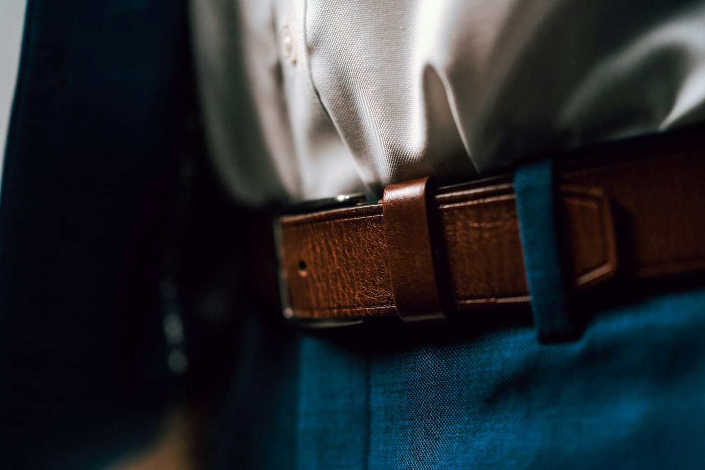 Accessories manufacturing context: an editorial photograph of a leather belt