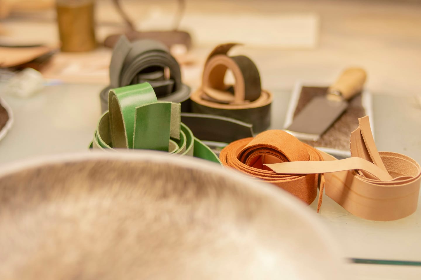 Leather manufacturing context: a leather belt strap being worked by hand