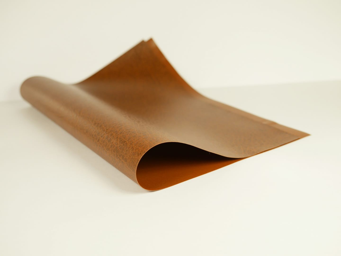 Material detail: rolled leather stored on a shelf
